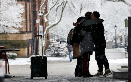 Students embrace on the main green