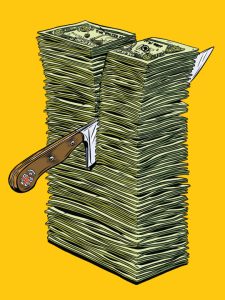 Knife cutting through a pile of money