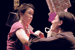 Photo of two people performing onstage.