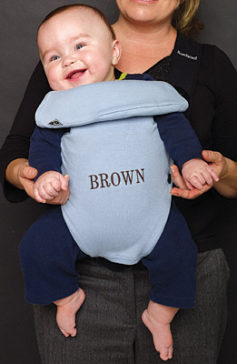 Photo of a baby in a carrier that is embroidered 