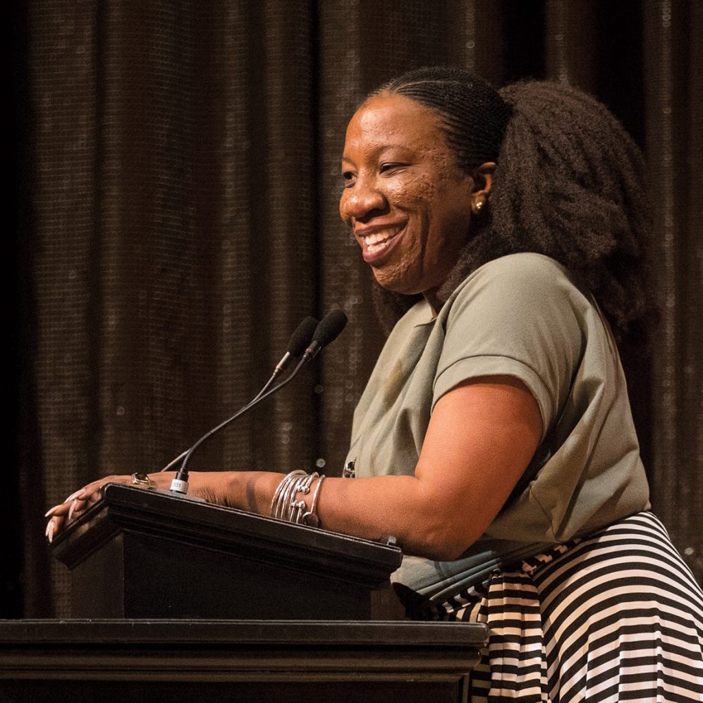 Tarana Burke stands at a podium
