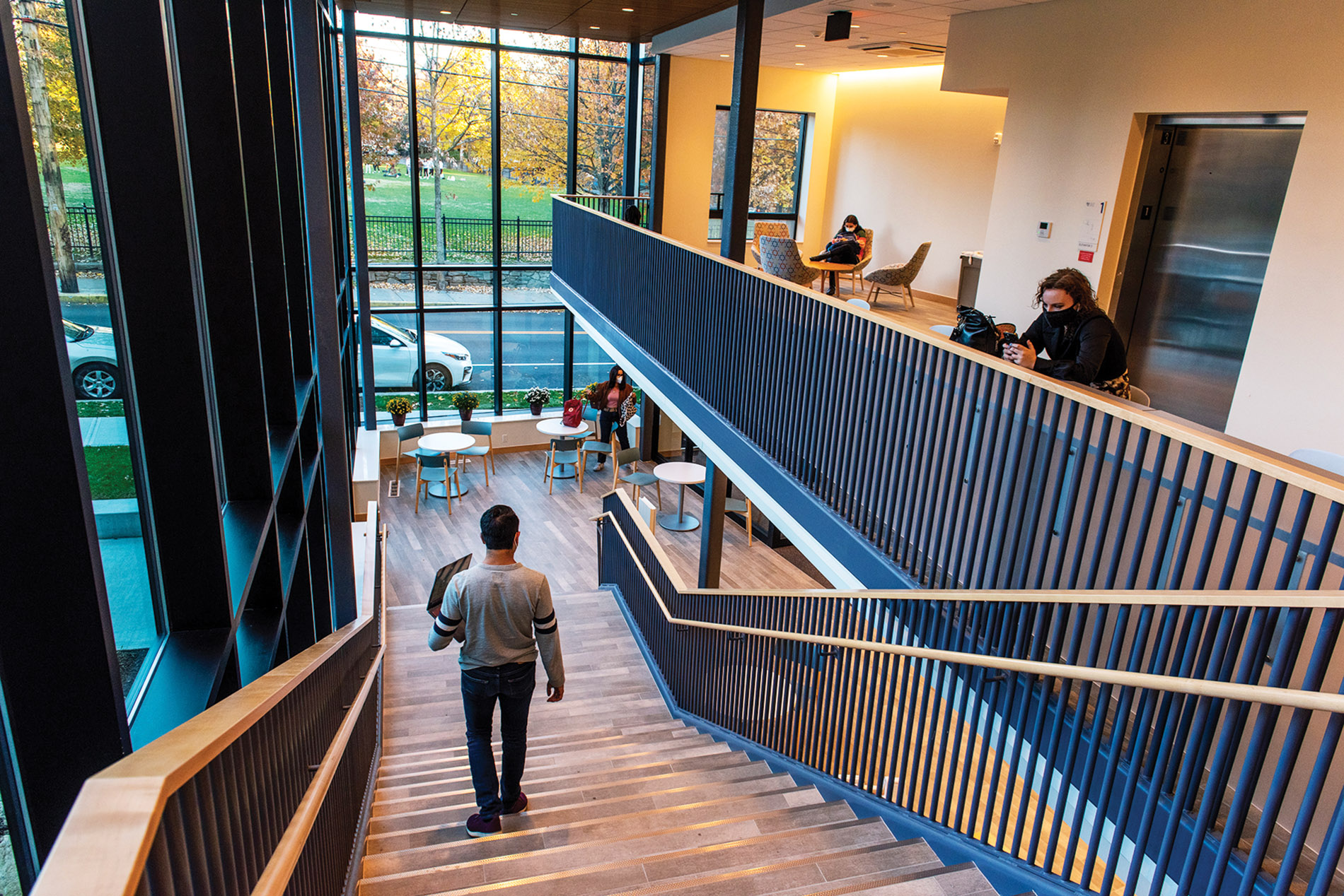 Image of a student walking down the stairs in Sternlicht Commons and Brown University Health & Wellness Center