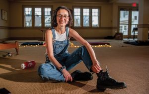 Image of Kaitlin Goldin sitting on the floor in the chapel at Hillel, Brown University