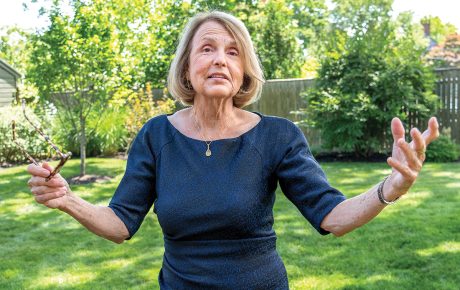 Image of Tracy Breton mid-explanation with green grass and trees in the background.