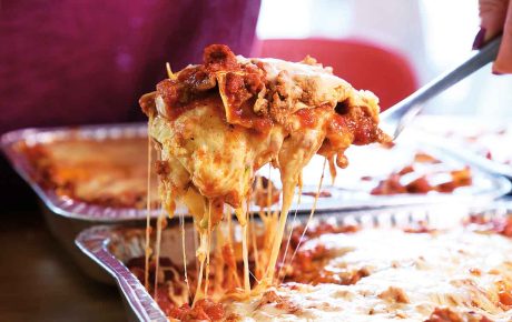 Image of lasagna coming out of the pan