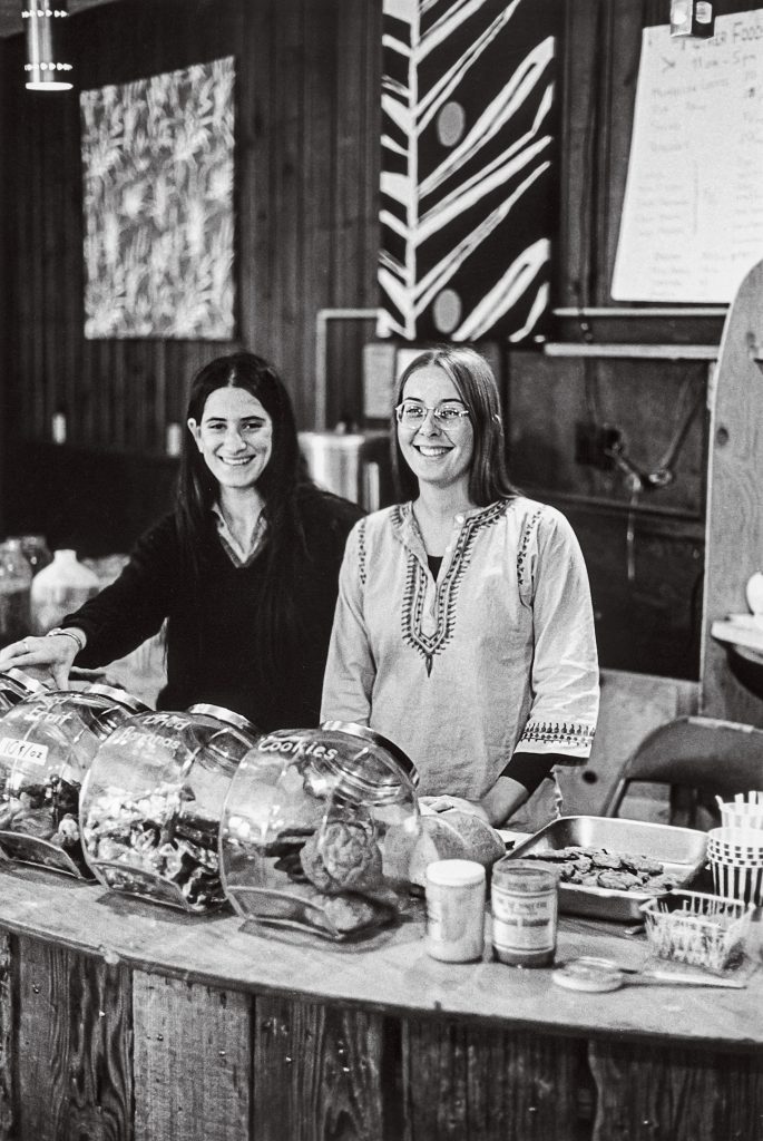 “Ahh! That Muenster on delicious pumpernickel!” remembers Marsha Jones ’76. Leslie Seeman ’73, left, pictured with Barb Goldman ’74, says they weighed the cheese to price it. Neil Ward ’76 sold his whole wheat raisin “NeilBread” to the student-run coffeehouse, where you could buy vinyl from Mother Records and hear live acoustic music at night. “Lots of bell bottoms, floral shirts and flowing skirts, fringed jackets and love beads!” says Tony Affigne ’76, ’91 AM, ’92 PhD. “The atmosphere at Big Mother was e