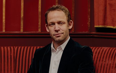 Image of Neidich sitting in a booth at his restaurant