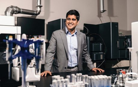 Image of Gaurab Ghakrabarti at Solugen surrounded by scientific equipment and test tubes.