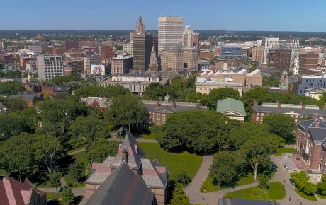 Overhead image of Brown campus in foreground and Providence in background.