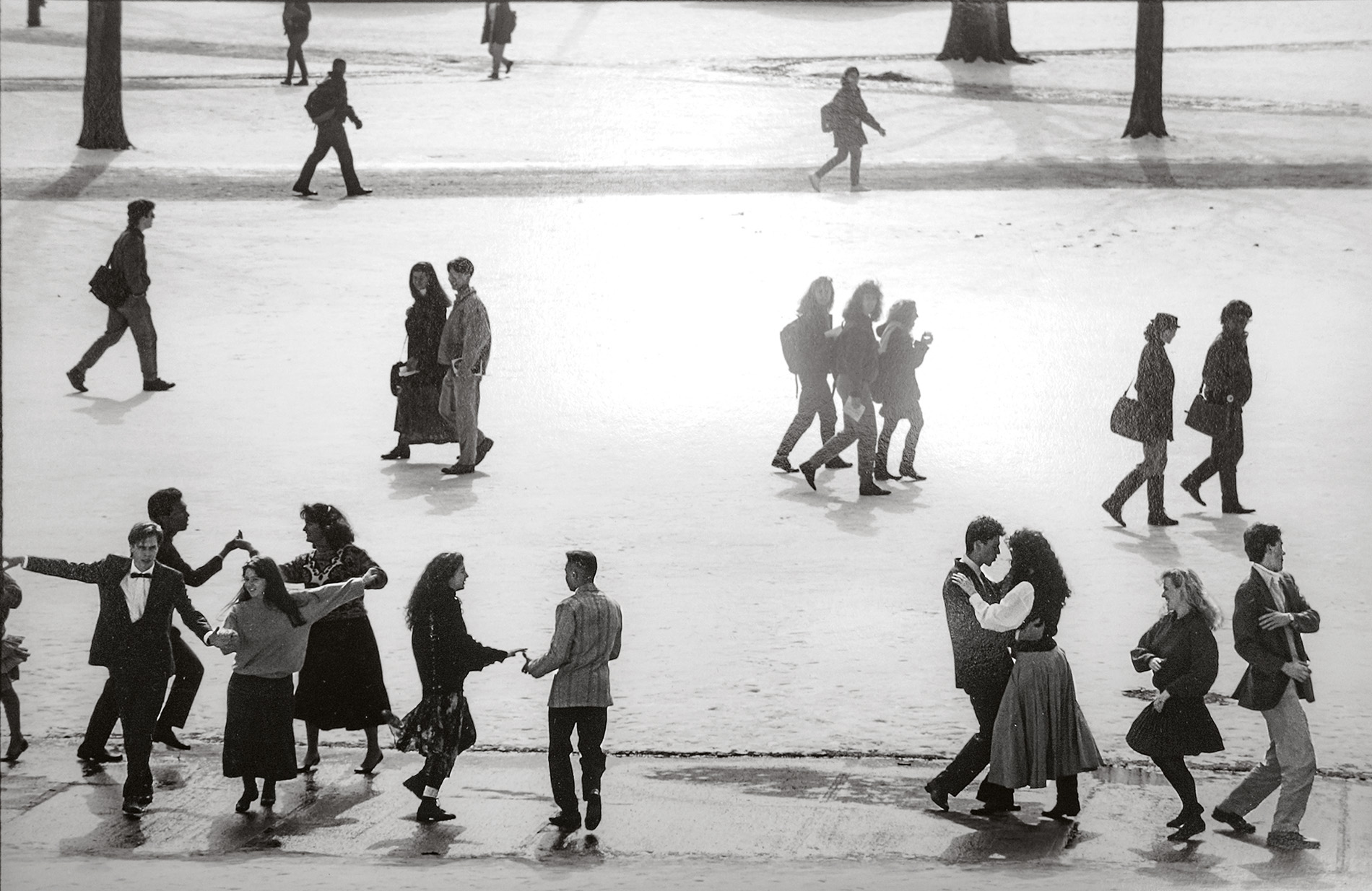 An archival image of students dancing on a snow-covered University green.