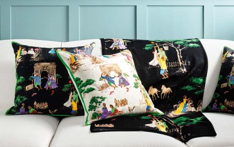 Image of Sheila Bridge's designs on pillows and blankets on a couch.