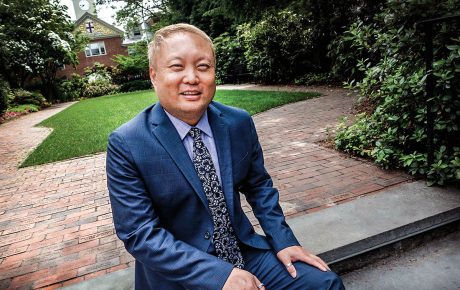Image of Eric Estes sitting on a bench on campus.