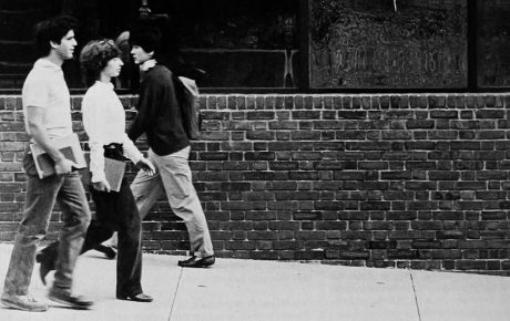 Archival image of students walking by the mirror glass of the 1984 BioMed Center