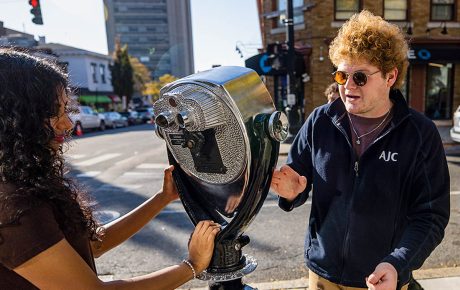 Image of Daniel Solomon ’26 working on The Blind Urban Subject installation on a Providence street.