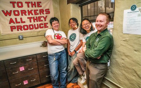 An image of Jo Ouyang, Yasmine Abdelaziz, Anna Ryu, and Michael Ziegler, with a sign in the background that states 
