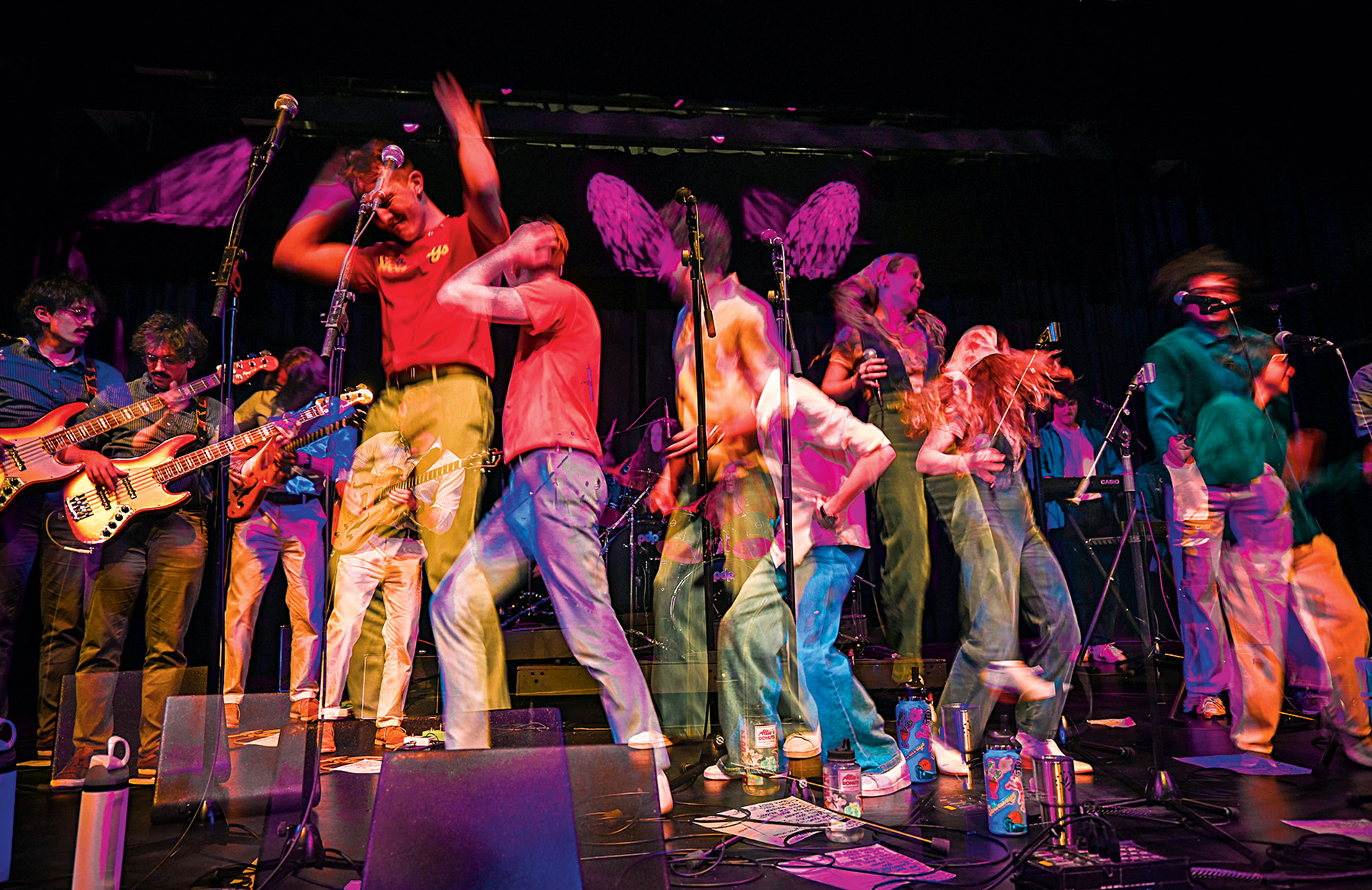 Super-imposed image of the band the Stowaways on stage.