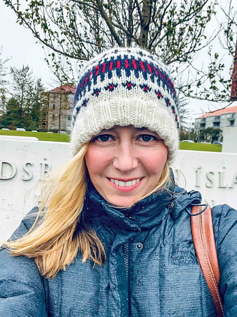 Image of Jenna Grace Sciuto wearing a hat and smiling at the camera