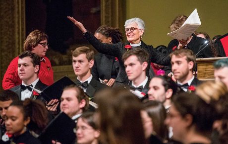 An image of Janet Cooper Nelson with students in tuxes in the foreground