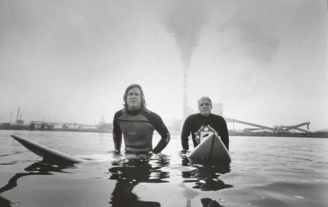Surfers sitting on their boards